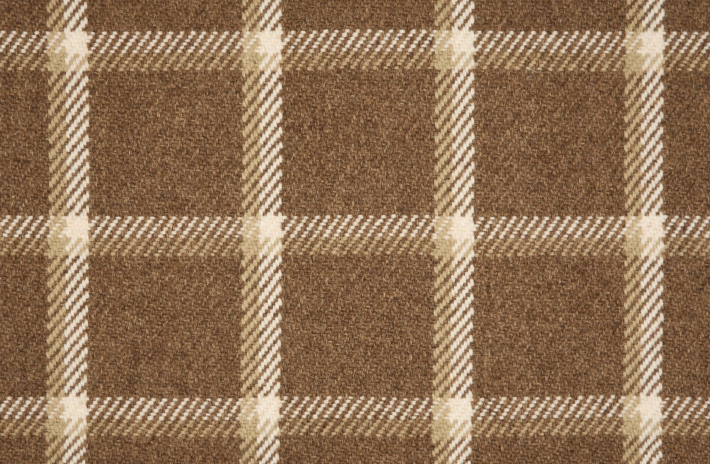 Broadloom carpet in a windowpane plaid in tan and cream on brown.