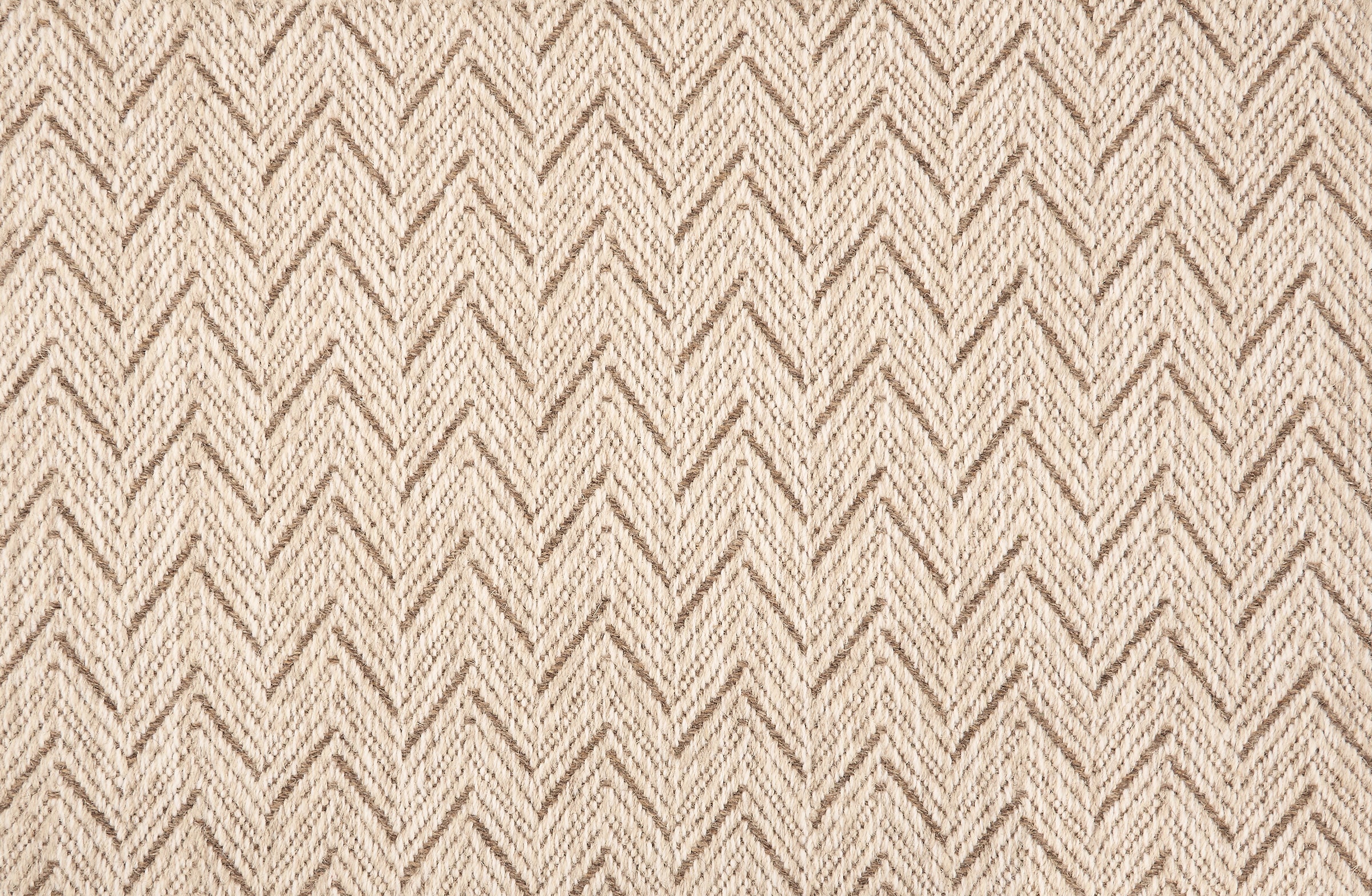 Broadloom carpet in a herringbone pattern in ecru with brown accents.