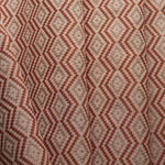 Close-up of fabric with red and beige zigzag pattern