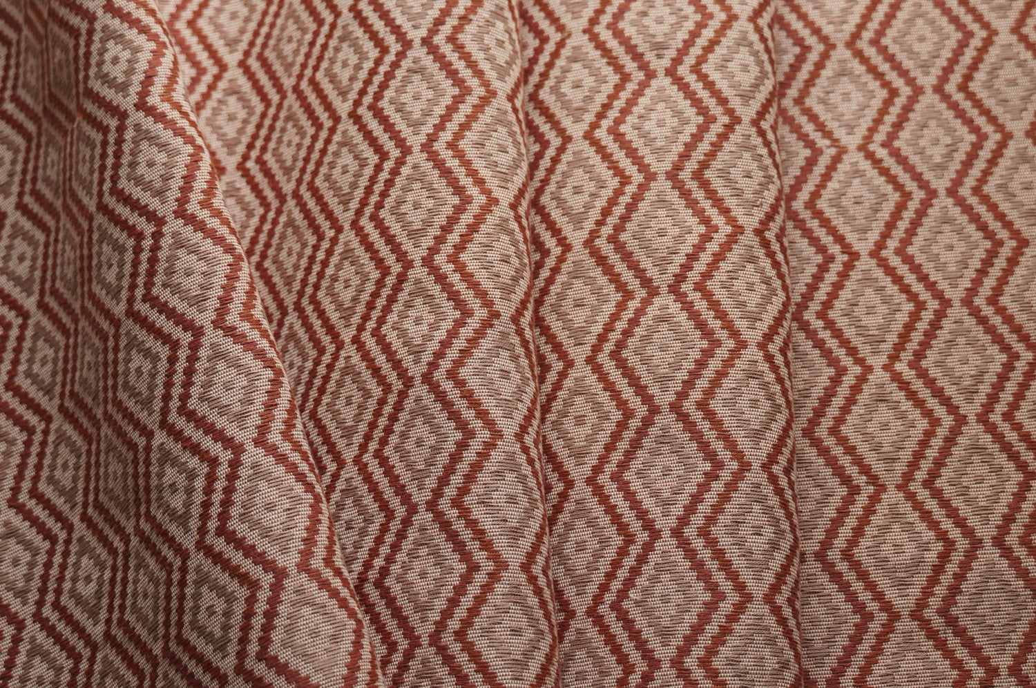 Close-up of fabric with red and beige zigzag pattern