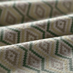 Close-up of textured fabric with geometric pattern in shades of green