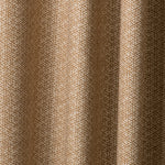 Draped printed fabric in a detailed geometric pattern in cream on a camel field.