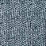Detail of a linen fabric in a detailed geometric pattern in white on an indigo field.