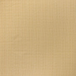 printed linen fabric in a detailed geometric pattern in white on a goldenrod field.