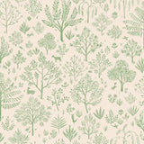 Detail of wallpaper in a playful animal and tree print in green on a cream field.