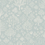 Detail of wallpaper in a playful animal and tree print in white on a light blue field.