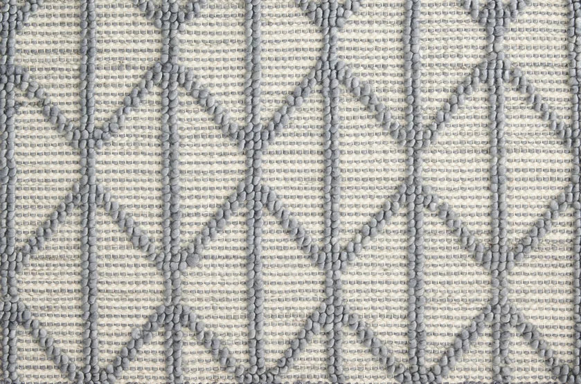 Broadloom carpet swatch in a diamond textured pattern in a blue design