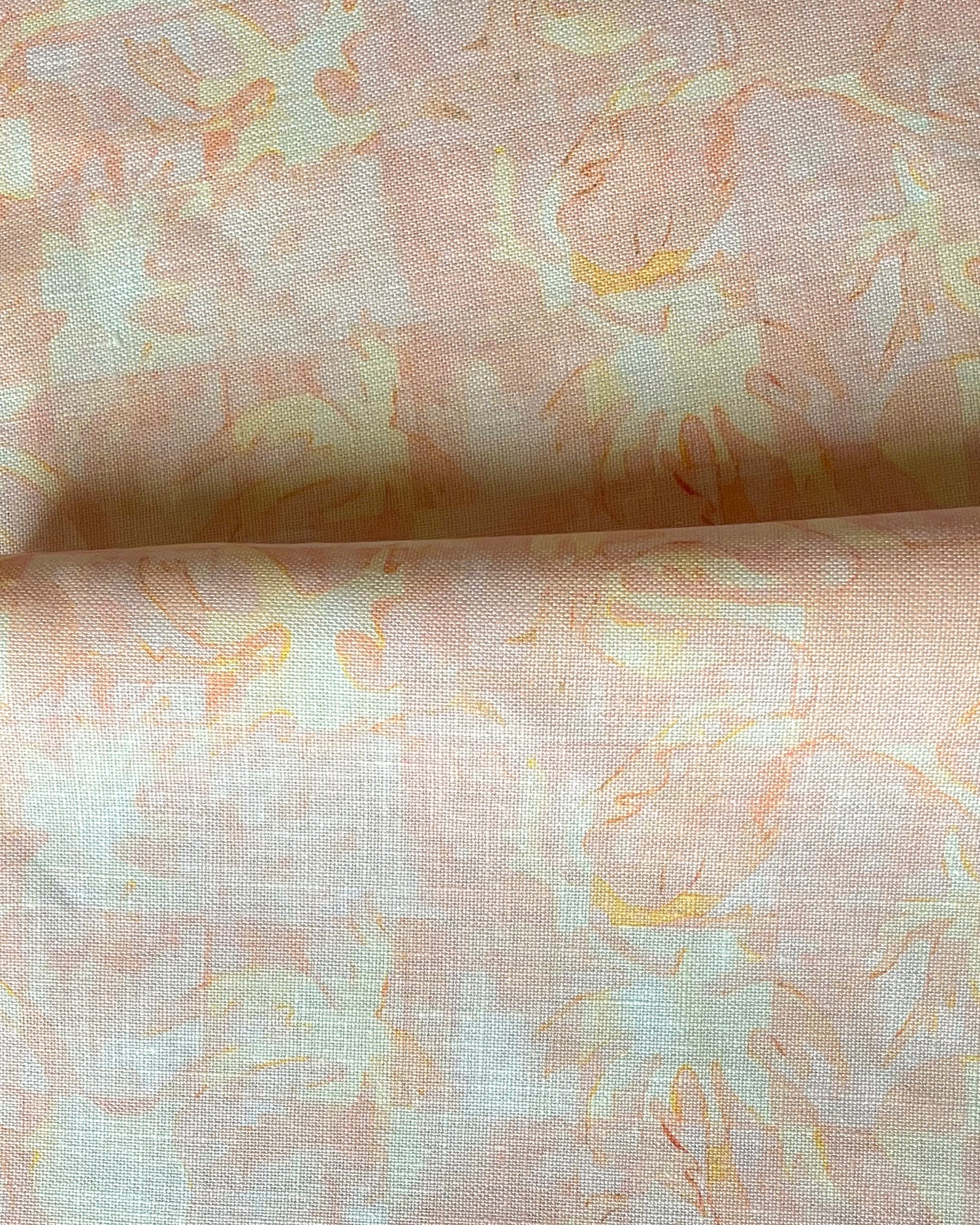 Drape fabric in painterly tropical checkerboard design in pinky orange and yellow. 