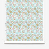 Wallpaper roll with painterly tropical checkerboard design in aqua blue, pink and tan.