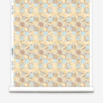 Wallpaper roll in painterly tropical checkerboard design in yellow, tan and blue. 