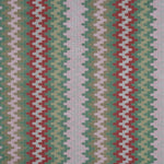 Handwoven silk fabric with zigzag design  in red, green, and white.