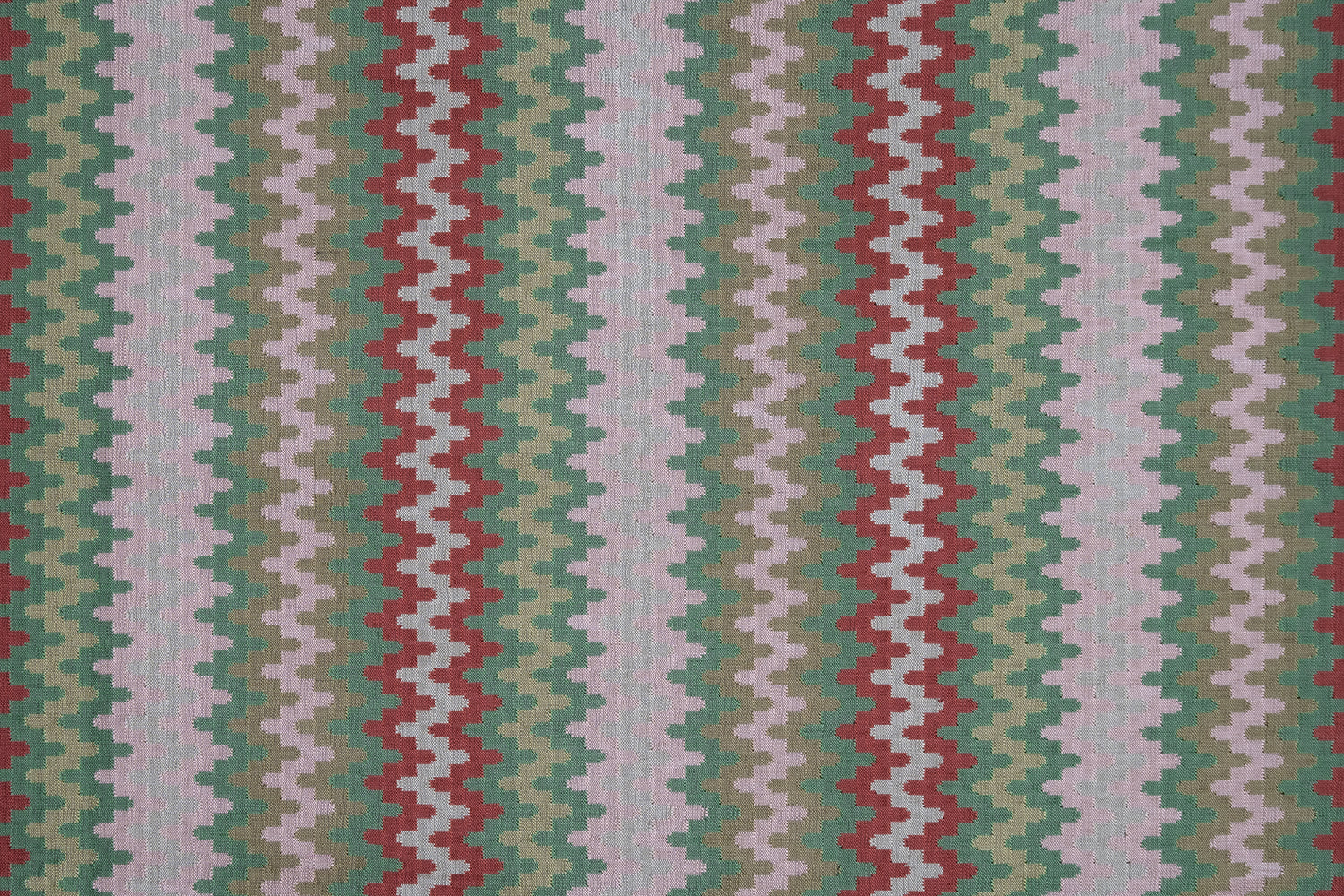 Handwoven silk fabric with zigzag design  in red, green, and white.