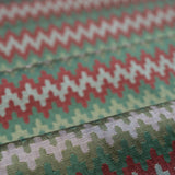 Close-up of fabric with a zigzag pattern in red, green, and white.