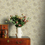 Decorative wallpaper with floral pattern, wooden dresser, and vase with flowers.