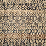 Handwoven rug detail in a contemporary design in black, grey, tan and cream