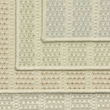 Stack of four broadloom carpet samples with textured stripe design in a palette of cream and pastel hues.