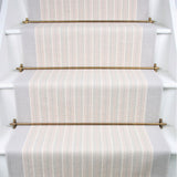 Striped herringbone flatweave runner in white and light grey on white staircase