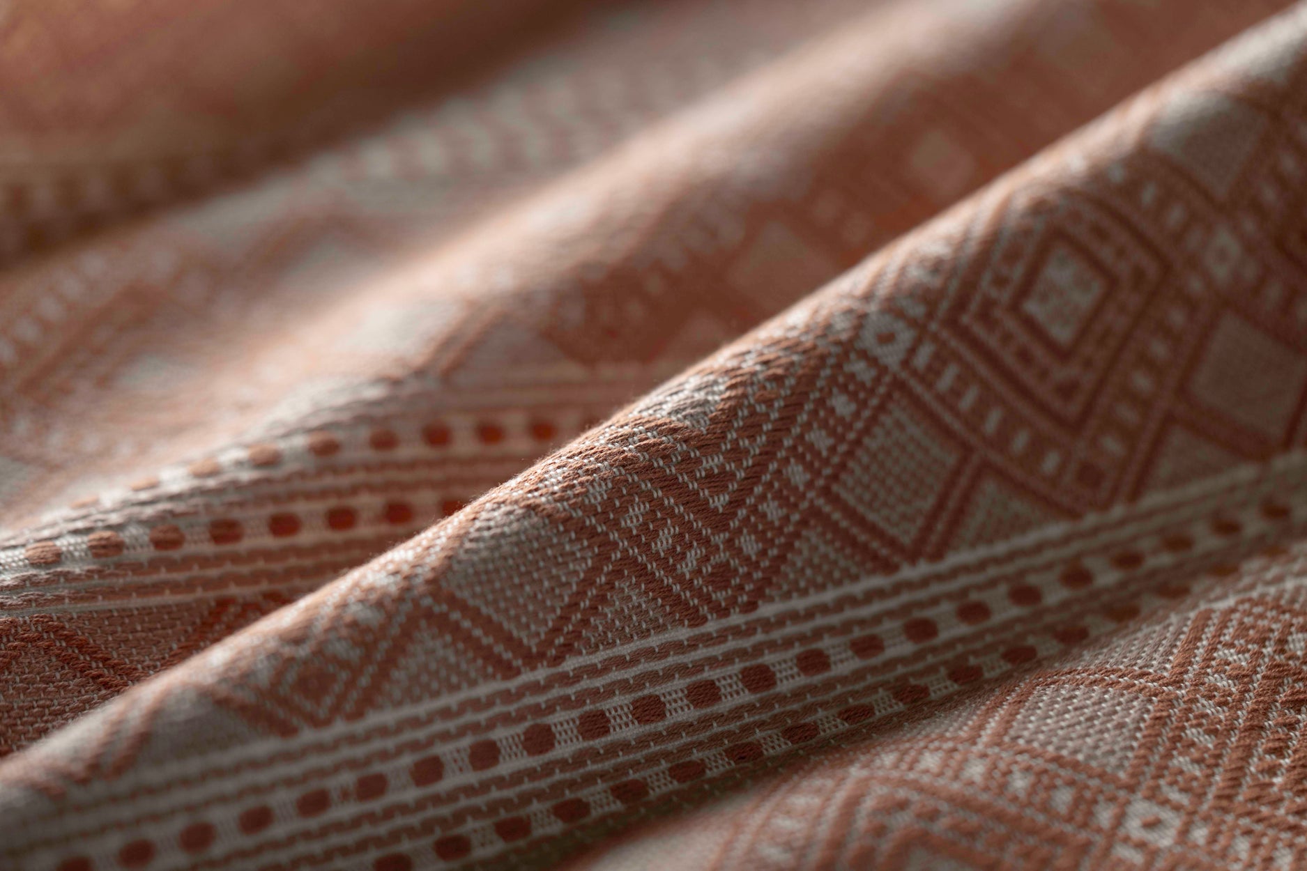 Close-up of textured brown fabric with geometric pattern