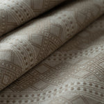 Close-up of textured beige fabric with geometric pattern