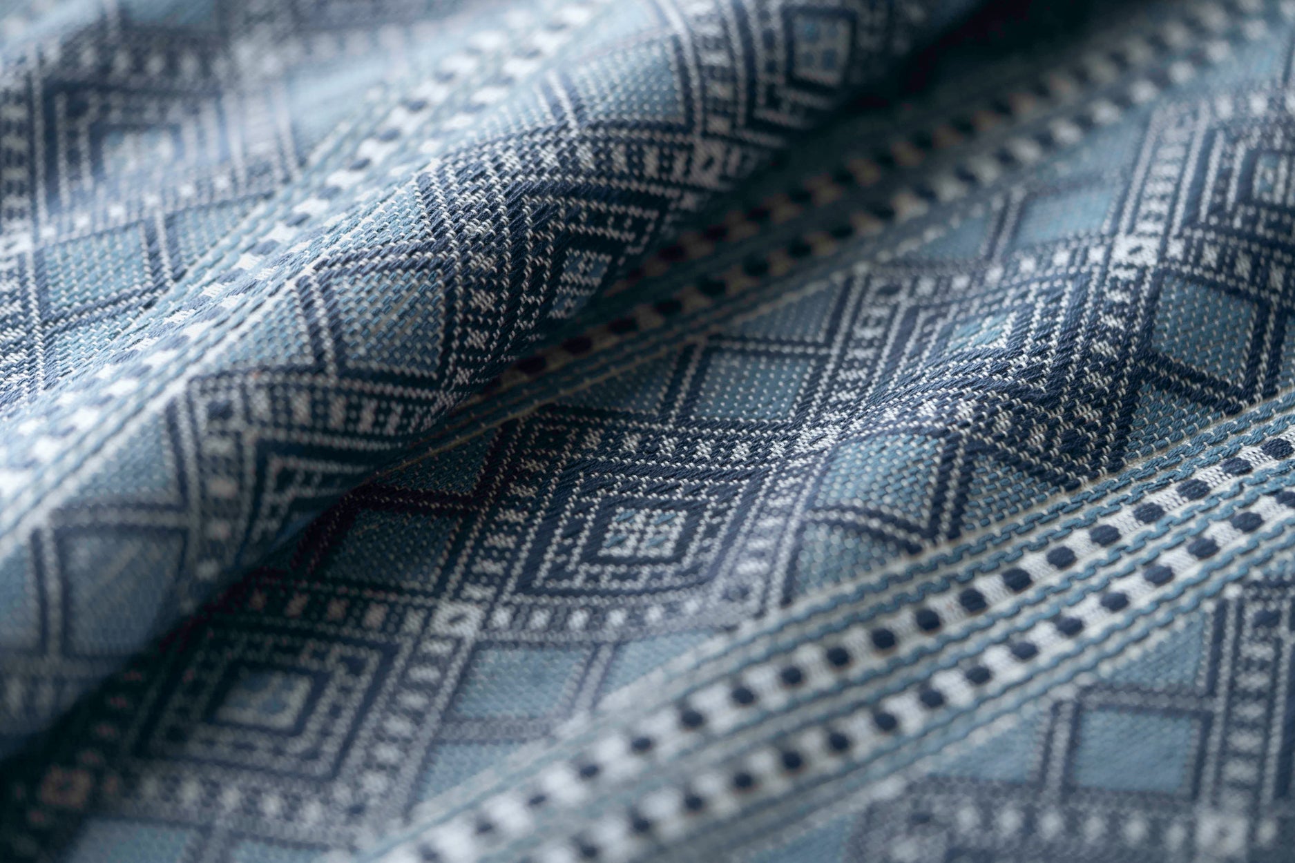 Close-up of textured fabric with geometric pattern in blue