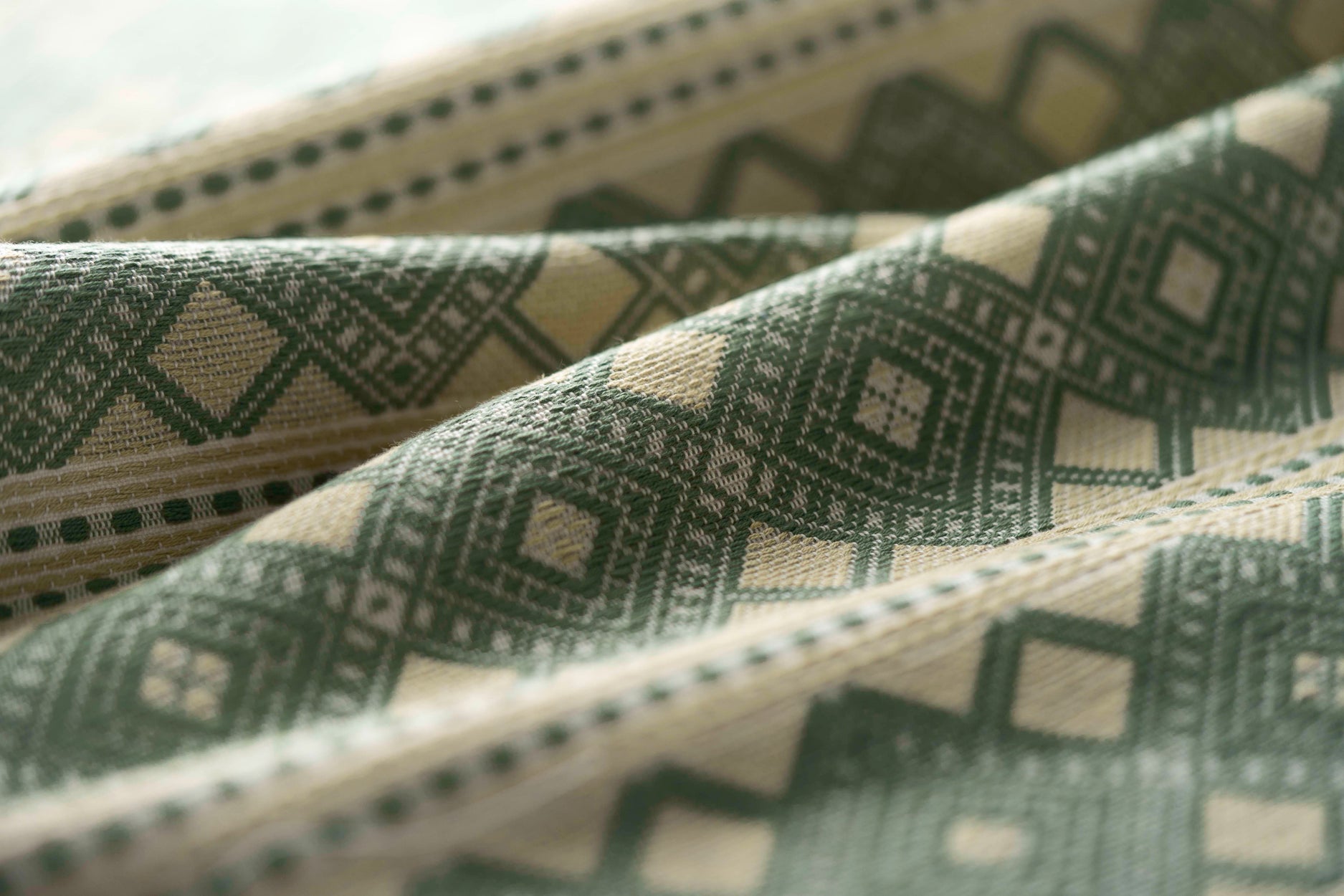 Close-up of patterned fabric with geometric design in green