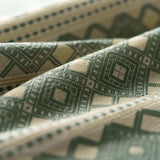 Close-up of patterned fabric with geometric design in green