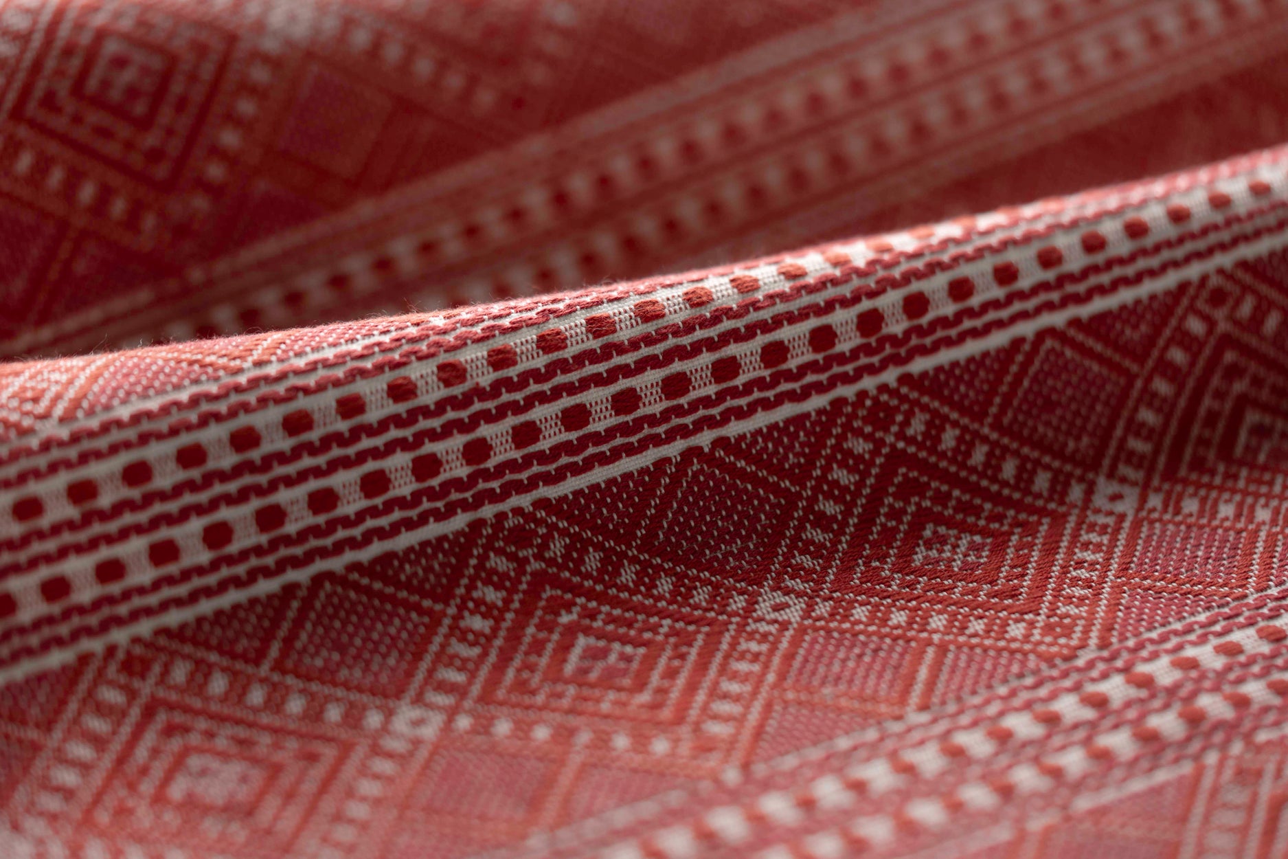 Close-up of patterned red abric with geometric design
