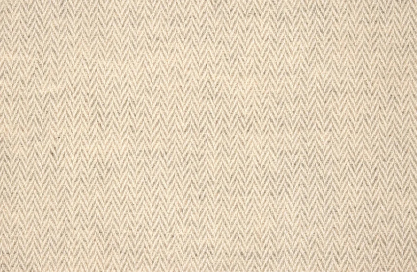 Broadloom carpet with a subtle herringbone pattern in taupe and ivory