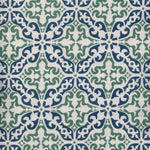 Detail of fabric in a damask print in green and navy on a cream field.