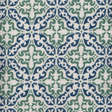 Detail of fabric in a damask print in green and navy on a cream field.