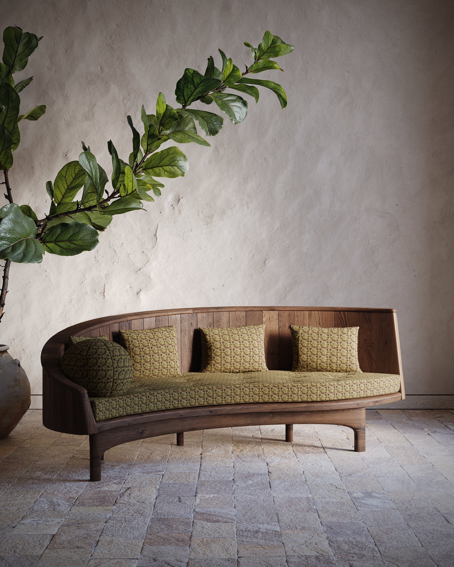 Curved wooden sofa with green cushions against a neutral wall with a plant.