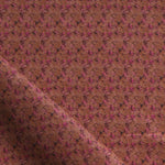 Fabric with small scale watercolor floral in purple on brown.