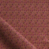 Fabric with small scale watercolor floral in purple on brown.