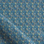 Fabric with small scale watercolor floral in green on teal.