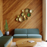 Modern living room with wooden walls, teal sofa, and decorative wall art.