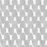 Detail of wallpaper in an abstract scalloped print in gray on a white field.