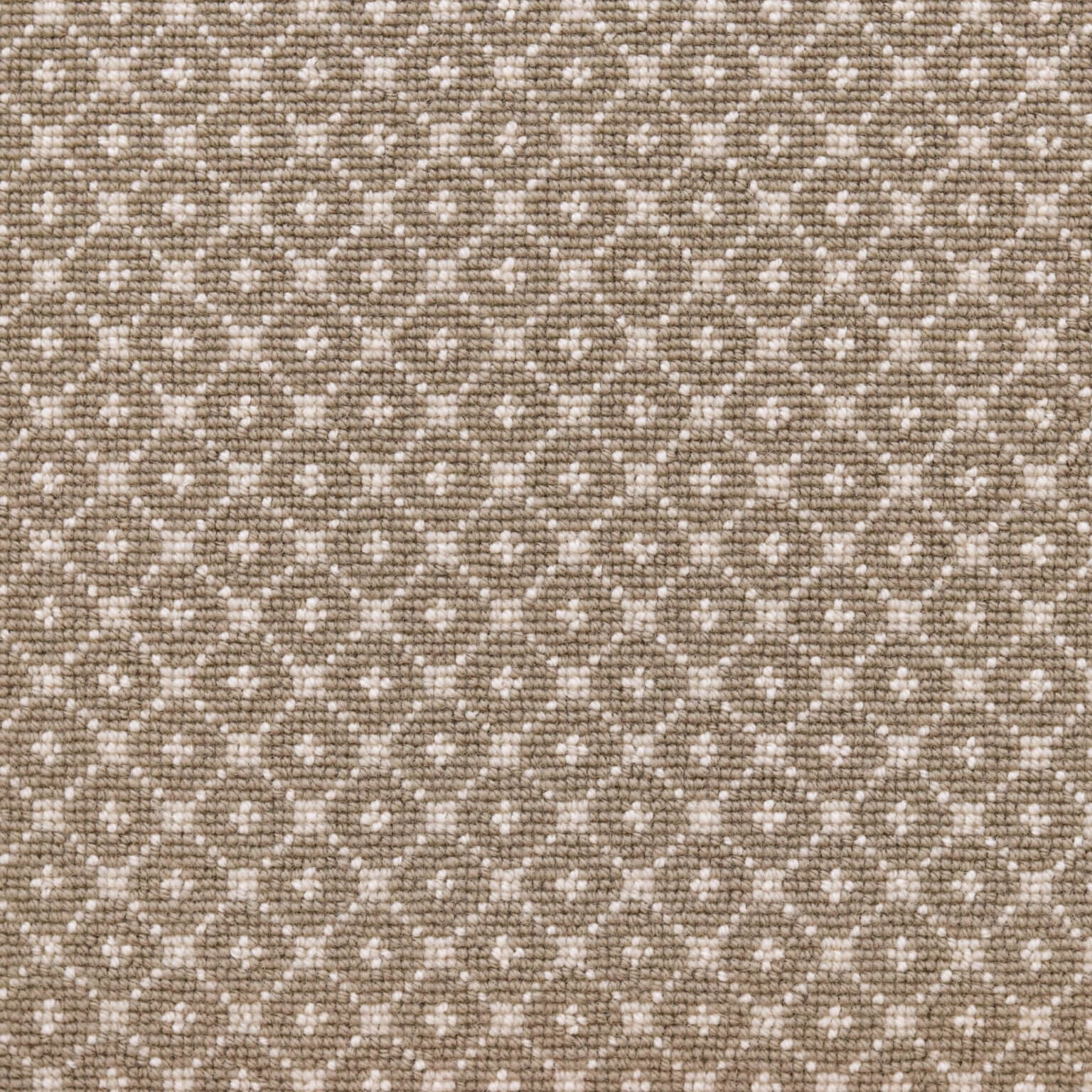 Broadloom carpet with dotted lattice in cream on a taupe field. 