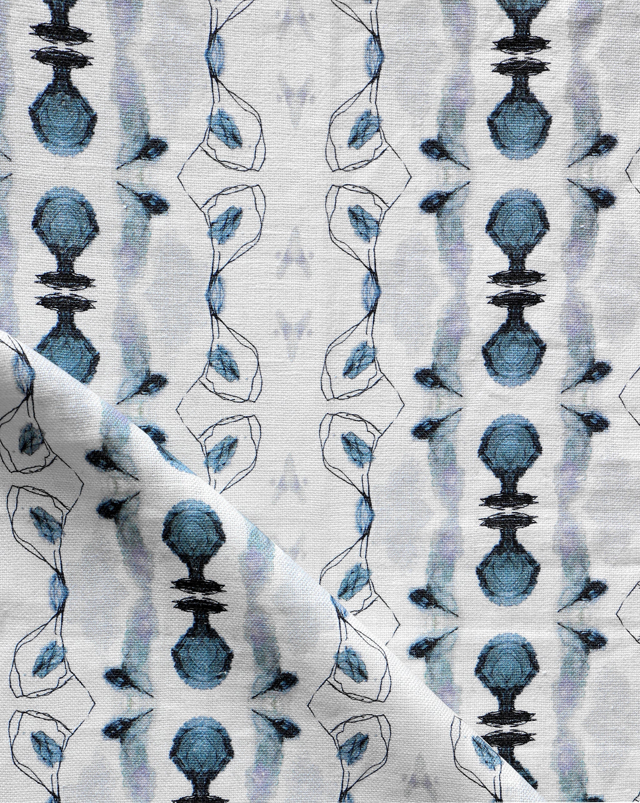 Detail of draped fabric yardage in a watercolor ikat stripe print in shades of blue and black on a white field.
