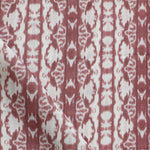 Detail of draped fabric yardage in a watercolor ikat stripe print in shades of white on a red field.