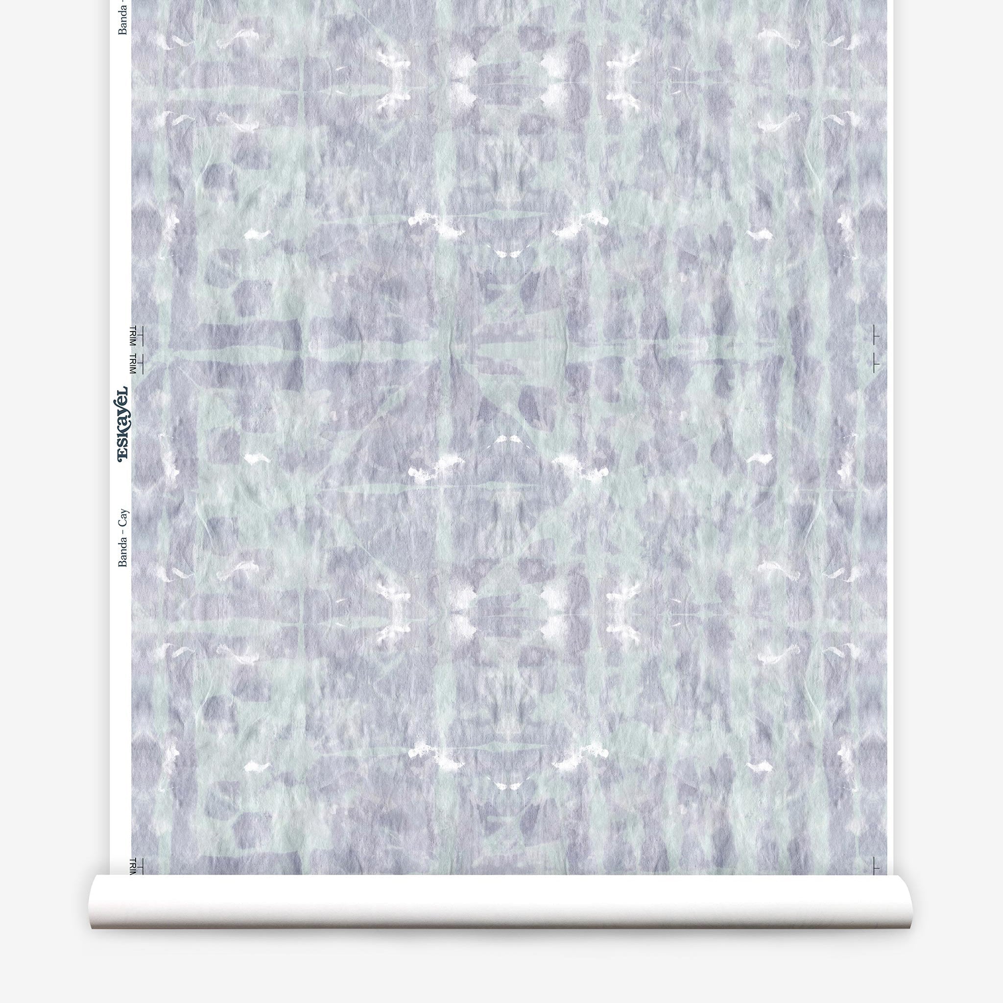 Partially unrolled wallpaper yardage in a watercolor dyed grid print in mottled purple and turquoise.
