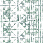 Detail of wallpaper in a watercolor dyed grid print in mottled white and green.