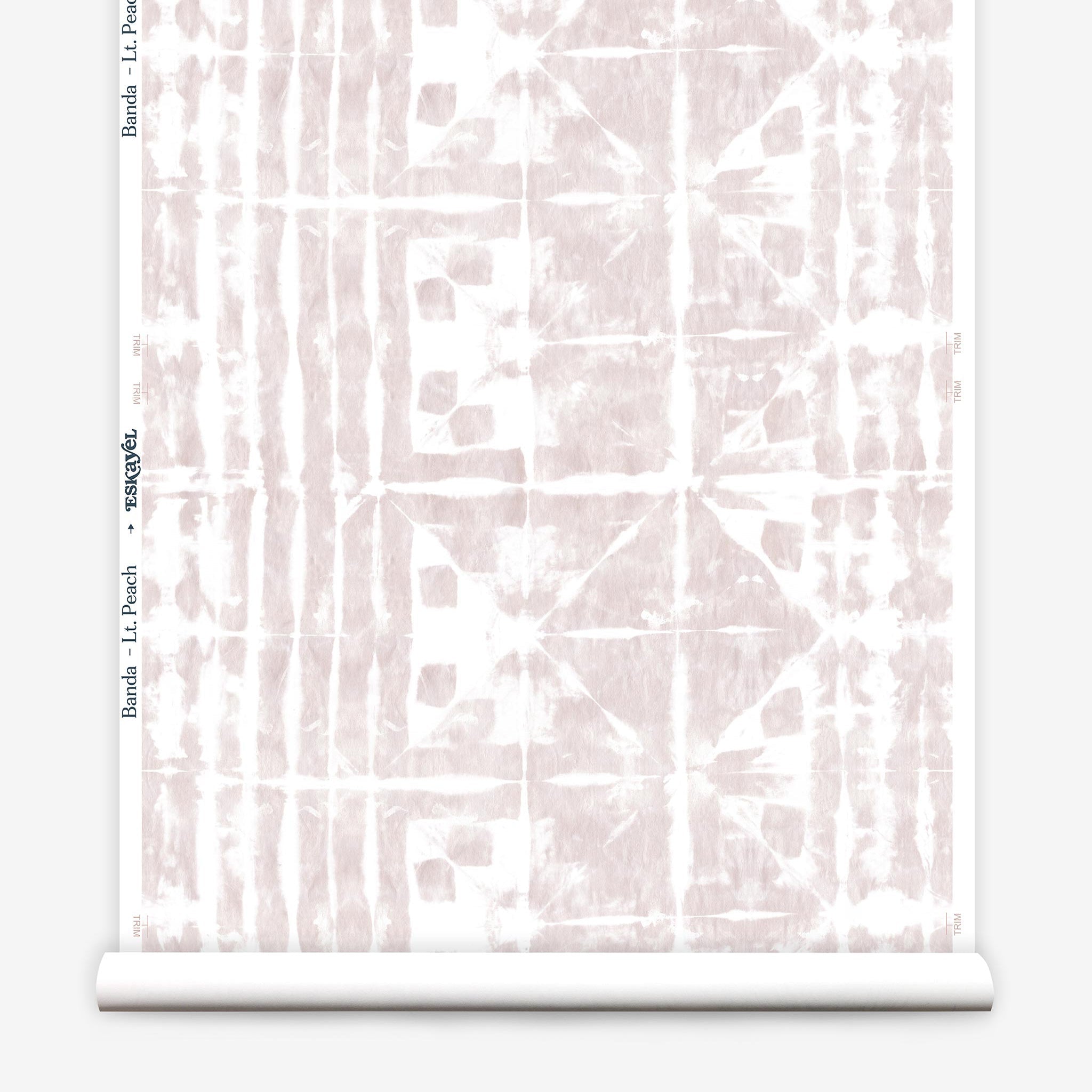 Partially unrolled wallpaper yardage in a watercolor dyed grid print in mottled white and pink.