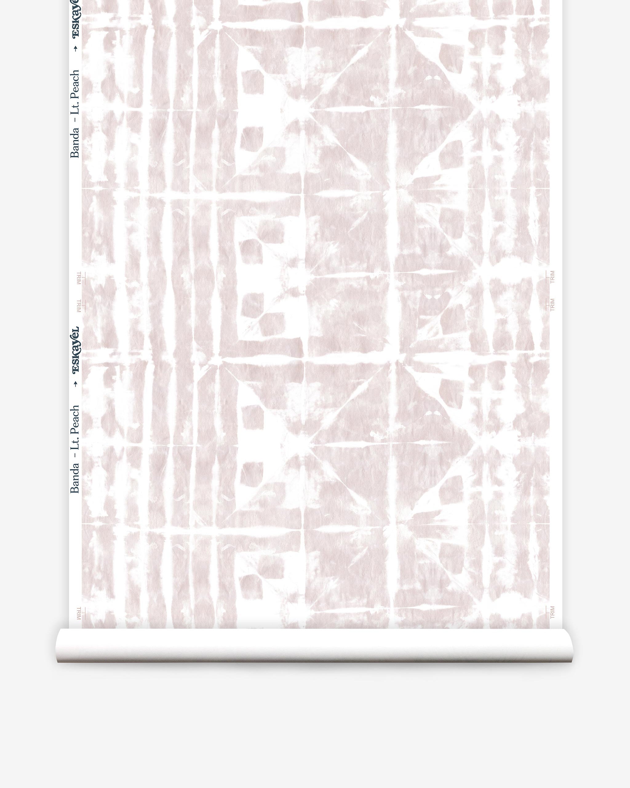 Partially unrolled wallpaper yardage in a watercolor dyed grid print in mottled white and pink.