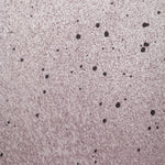 Close up of paint splatters in purple, gray and white.