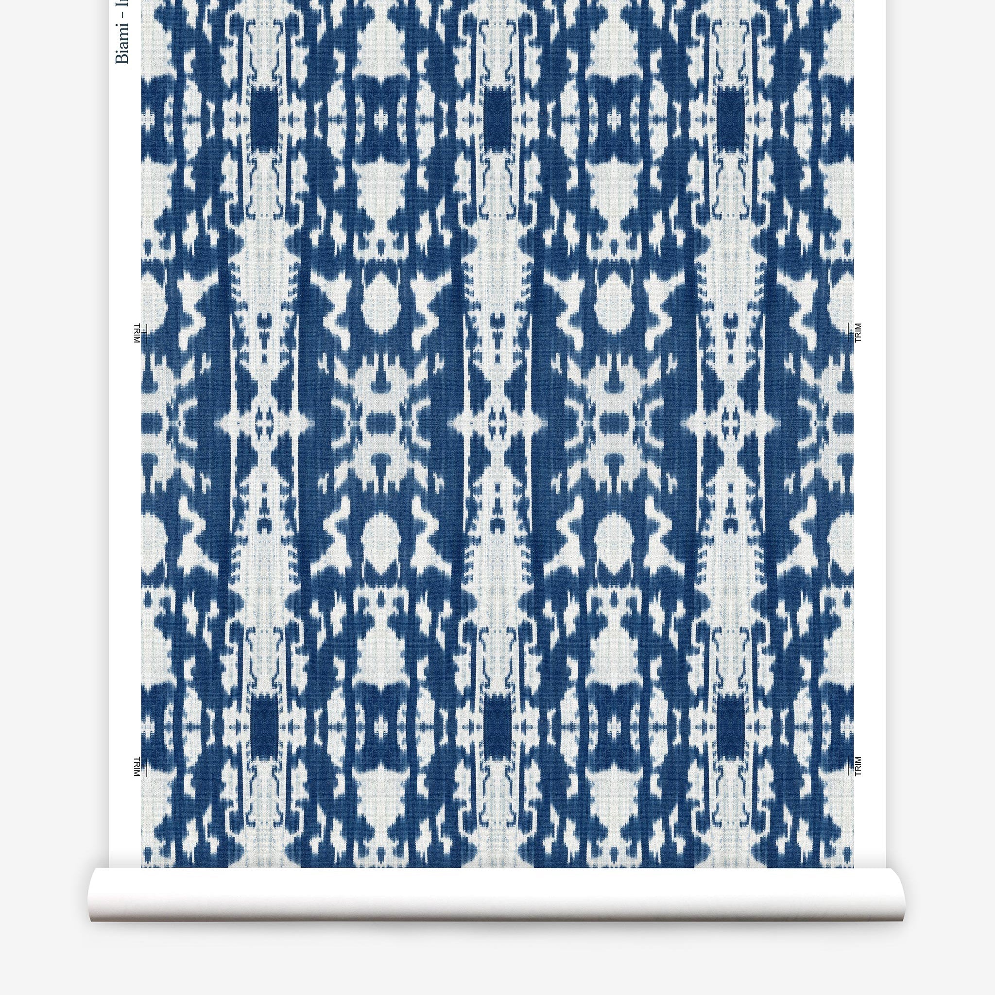 Partially unrolled wallpaper yardage in a painterly ikat print in blue and white.