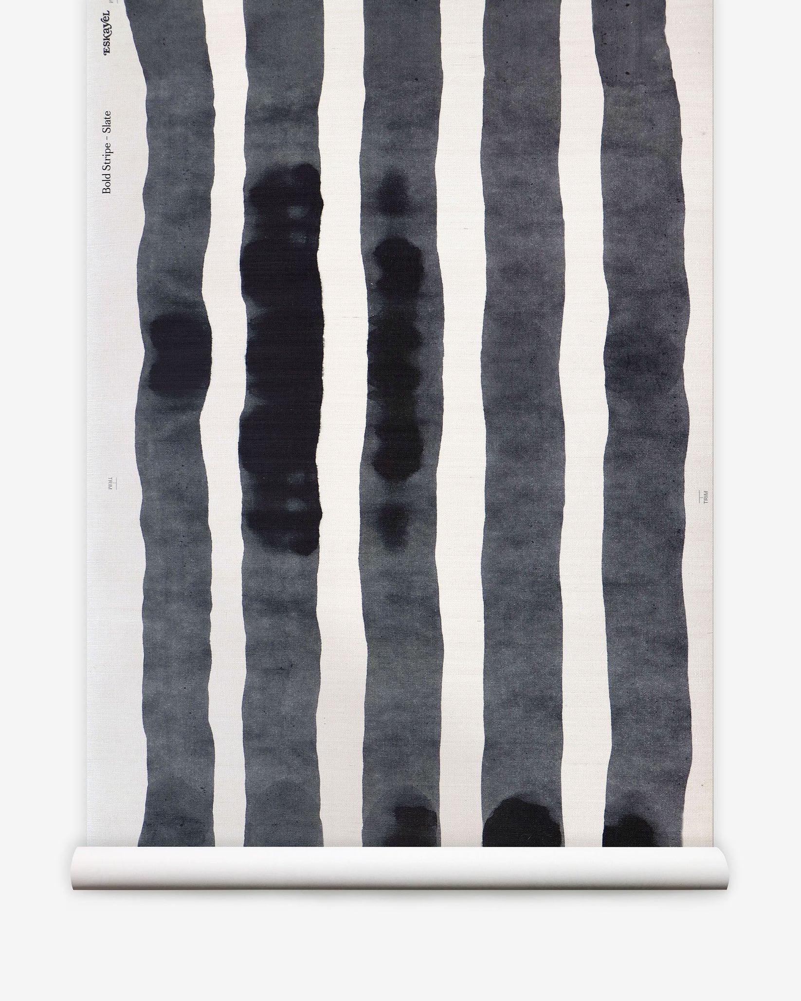 Grasscloth Wallpaper roll with bold watercolor stripes in black and white on a white background. 