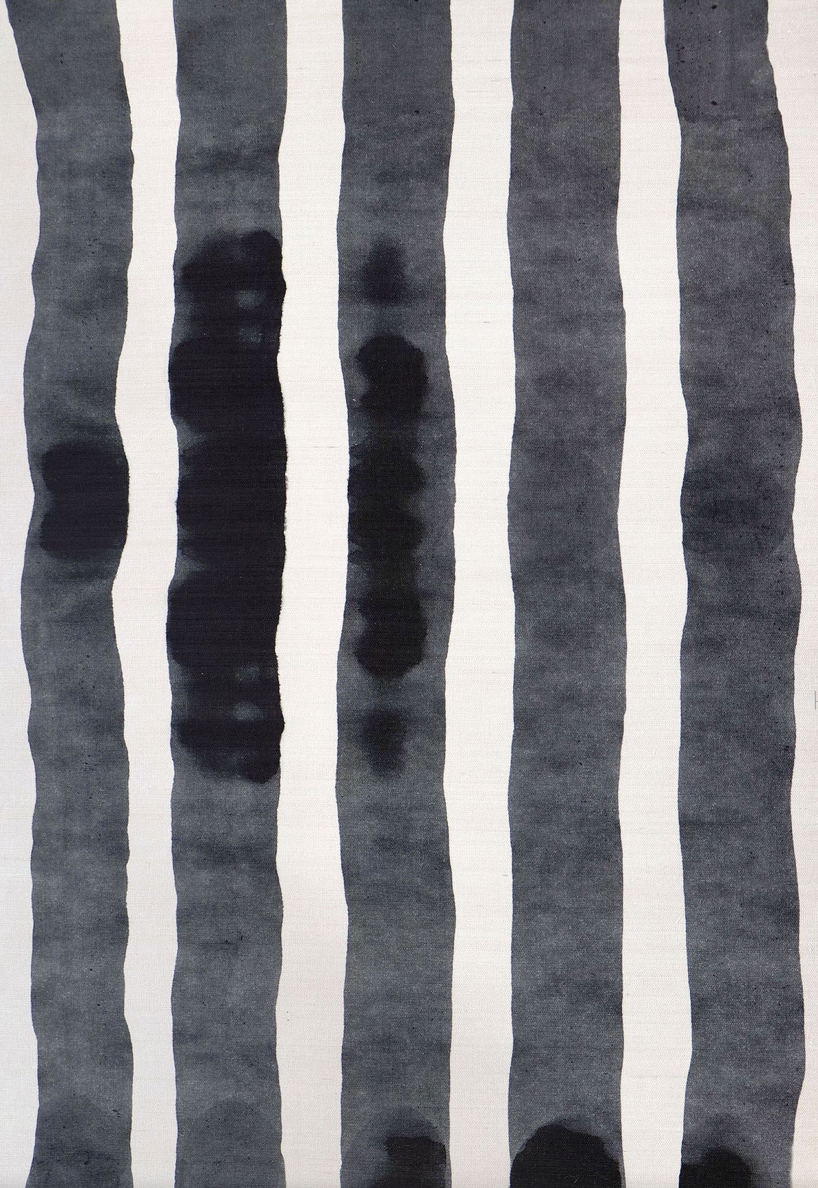 Grasscloth Wallpaper close up with bold watercolor stripes in black and white. 