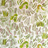 Detail of wallpaper in a playful leaf print in shades of green and red on a cream field.