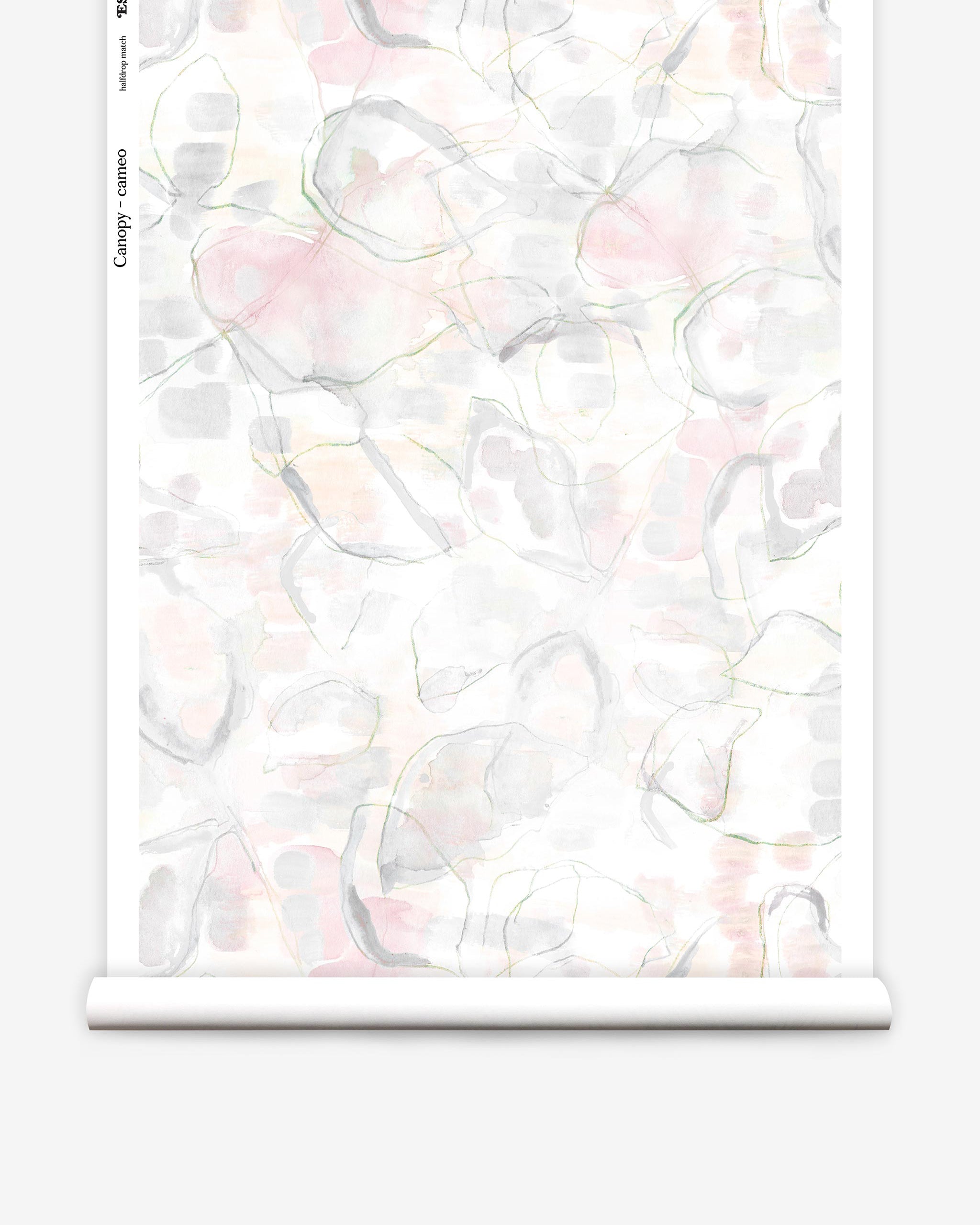 Partially unrolled wallpaper yardage in a watercolor painterly print in shades of pastel, green and cream.