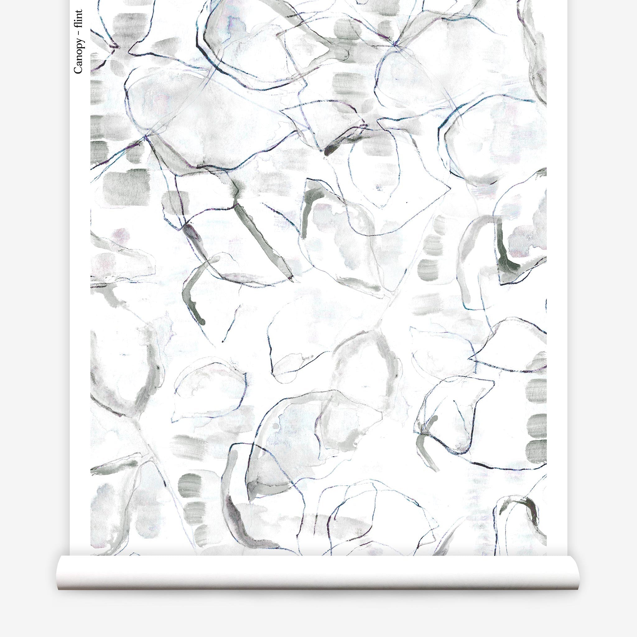 Partially unrolled wallpaper yardage in a watercolor painterly print in shades of gray, purple and cream.